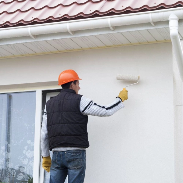 A man Painting a House Exterior Space in Dubai