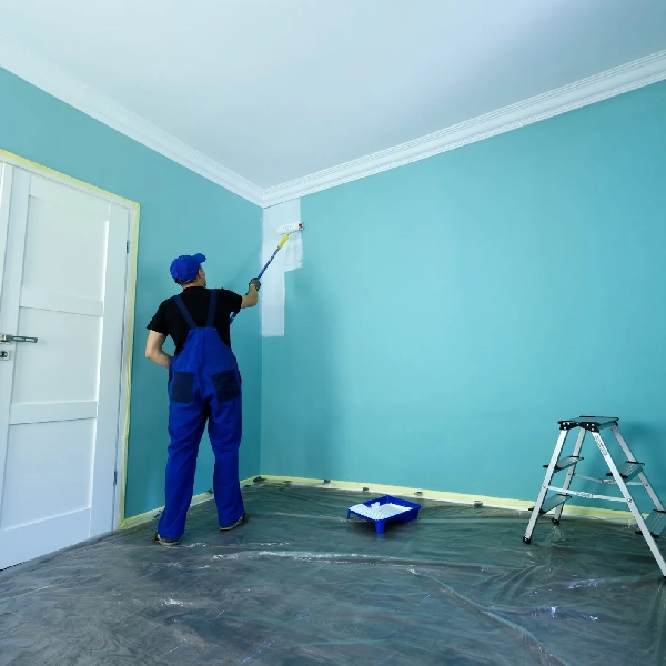 A man painting a wall for interior look in Dubai